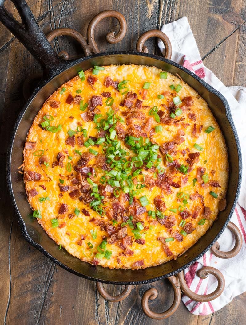 overhead view of keto loaded cauliflower casserole in a cast iron skillet