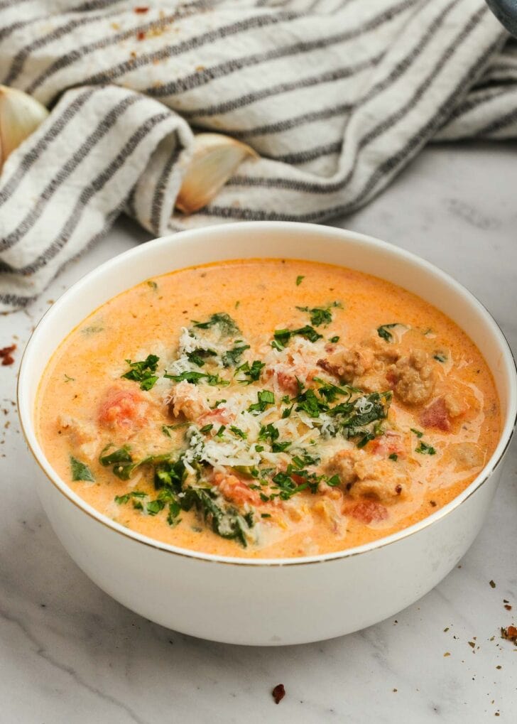 a bowl full of sausage spinach soup